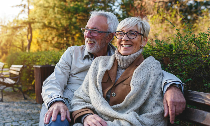 Senior Couple On Bench In Park