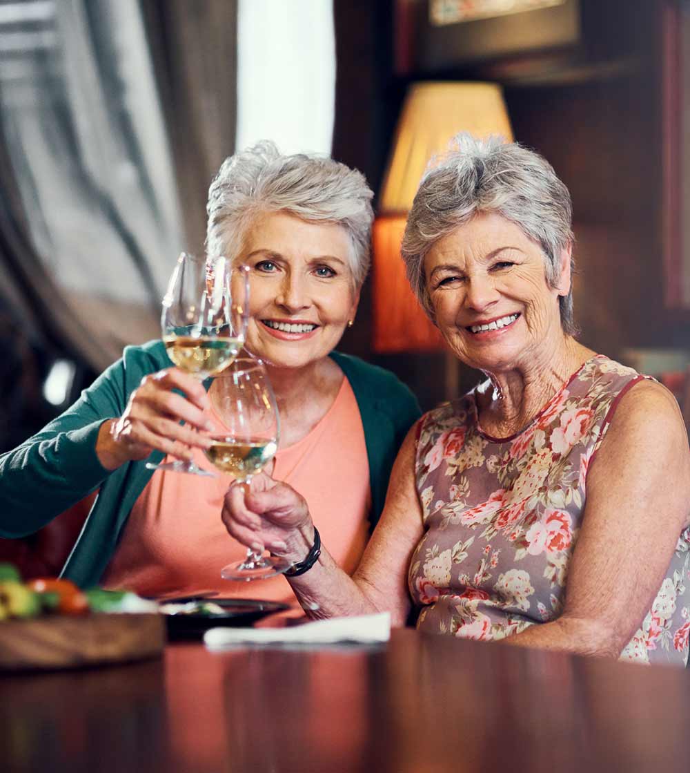 Senior Citizens celebrating during social hour at senior living community