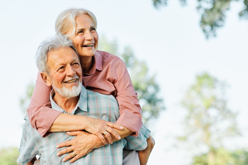 Happy active senior couple having fun outdoors.